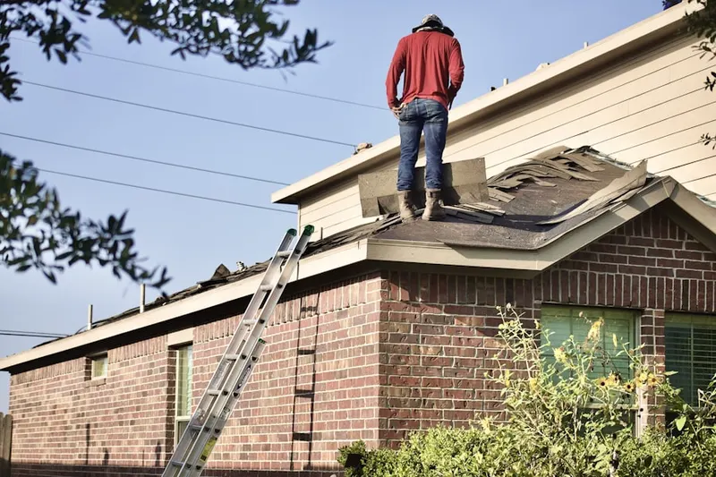 Professional roofer working on a residential roof in Martisco